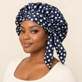 Navy polka-dot bonnet on a model